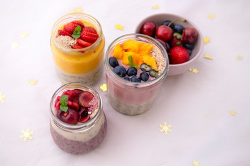 Chia pudding and fresh fruit smoothie, mango, berry, cherry with christmas decoration