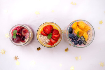 Chia pudding and fresh fruit smoothie, mango, berry, cherry with christmas decoration