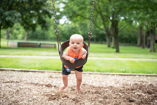 Baby On Swing In Park