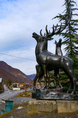 Fototapeta na wymiar Zhinvali, Georgia An elk statue stands by the side of the road.