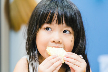 5 years old girl.Little asian thai girl eating durian fruit at home.She make every happy and yummy...