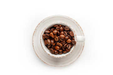 Cup of coffee with fried beans on white  background, isolate