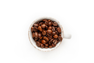 Cup of coffee with fried beans on white  background, isolate