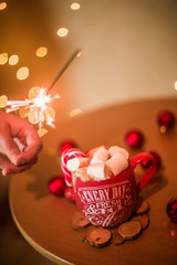 on the table is a cup with a drink and marshmallows