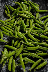 green peas, on asbestos black and white background, in a rustic style