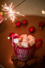 on the table is a cup with a drink and marshmallows