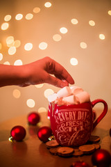 on the table is a cup with a drink and marshmallows