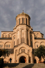 Fototapeta na wymiar Tbilisi, Georgia Pedestrians walking around the Holy Trinity Cathedral of Tbilisi