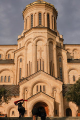 Fototapeta premium Tbilisi, Georgia Pedestrians walking around the Holy Trinity Cathedral of Tbilisi