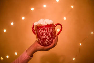 Photo of a cup with a drink and with marshmallows and Christmas candy
