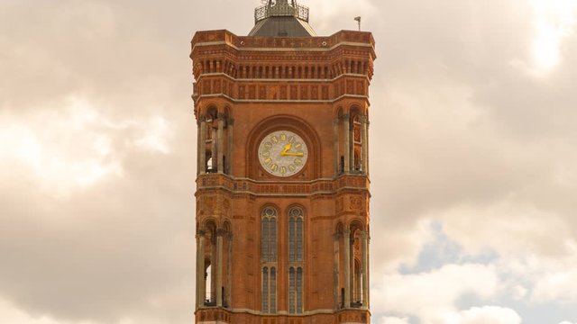 The Rotes Rathaus is the town hall of Berlin, located in the Mitte district on Rathausstra&szlig;e near Alexanderplatz. Berlin time lapse of clok on town hall in germany time lapse close up view.