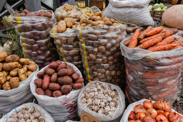 Tbilisi, Georgia The busy fruit and vegetable market at Station Square and a selction of carrots, onions, potatoes and garlic.