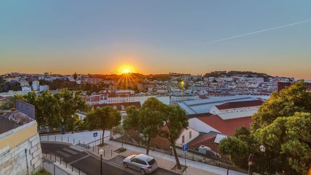 Sunrise over Lisbon aerial cityscape skyline timelapse from viewpoint of St. Peter of Alcantara, Portugal. Historical buildings from above at morning