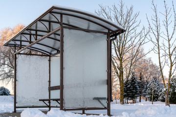 Bus stop with frozen glass in a winter morning