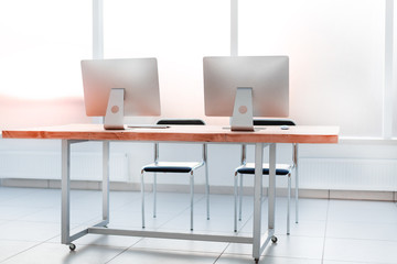 close up. workplace with computers on the table in an empty office.