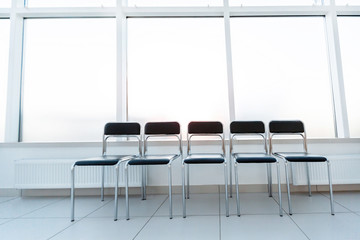 row of chairs in the office hallway .