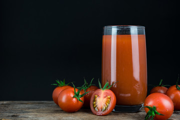 Tomatoes juice on black background