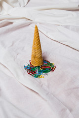 a group of colorful paper clips  with cone textured on white background