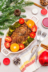 Fototapeta na wymiar Baked duck breast on the bone with vegetables and sauce. Christmas dinner concept, New Year table setting. Stone concrete background