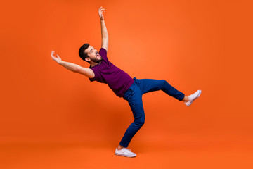 Fototapeta na wymiar Side profile full length body size of confused man falling down being blown by gust of wind in white foot wear isolated screaming over vivid color background