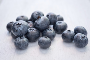 blueberries on wood white background