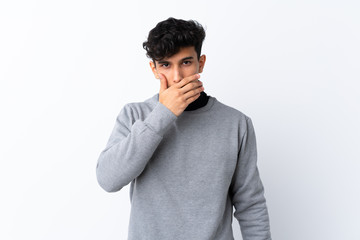 Young Argentinian man over isolated white background covering mouth with hands