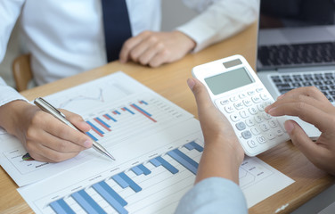 Meeting a team of businessmen, Executives and accountants meeting about the company's revenue graph in the office with laptops and calculators, Finance concept