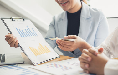 Meeting a team of businessmen, Executives and accountants meeting about the company's revenue graph in the office with laptops and calculators, Finance concept