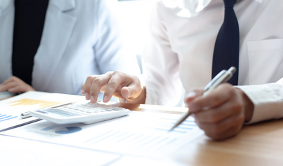 Meeting a team of businessmen, Executives and accountants meeting about the company's revenue graph in the office with laptops and calculators, Finance concept