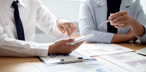 Meeting a team of businessmen, Executives and accountants meeting about the company's revenue graph in the office with laptops and calculators, Finance concept