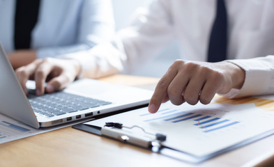 Meeting a team of businessmen, Executives and accountants meeting about the company's revenue graph in the office with laptops and calculators, Finance concept