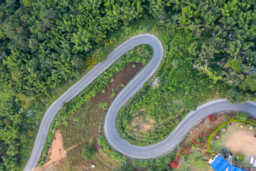 Aerial view of cars driving curves on the mountains and beautiful roads suitable for holiday travel in chiangrai, thailand