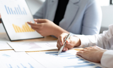 Meeting a team of businessmen, Executives and accountants meeting about the company's revenue graph in the office with laptops and calculators, Finance concept