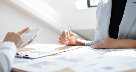 Meeting a team of businessmen, Executives and accountants meeting about the company's revenue graph in the office with laptops and calculators, Finance concept