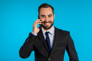 Naklejka premium Close up portrait of businessman have conversation using mobile phone. Business guy in formal suit gladly talks with colleague. Office employee, wage worker, weekdays concept