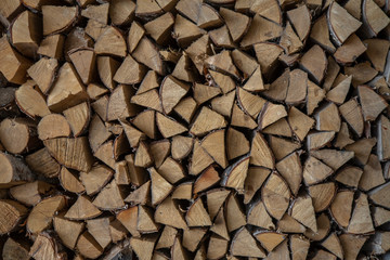 woodpile of dry chopped birch firewood. rough surface texture