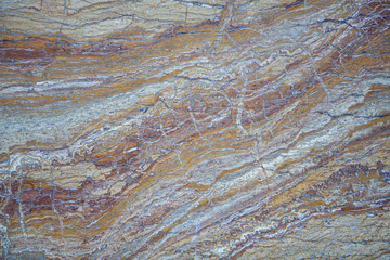 smooth red, gray marble stone with cracks. rough surface texture