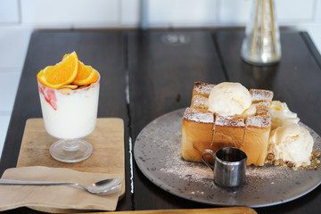 Honey Toast with whipped ice cream and yogurt orange in glass
