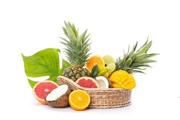 Wicker basket with fresh exotic fruits isolated on white background