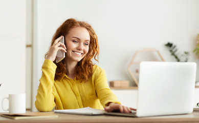 Business talk. Happy woman with laptop and phone