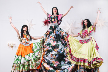 three female dancers in traditional Gypsy dresses