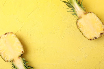 Pineapple halves on yellow background, space for text. Juicy fruit