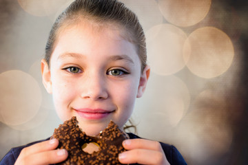 Naklejka premium cute little girl crunching in a chocolate donut