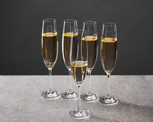 Foto op Aluminium champagne in glasses for celebrating christmas eve on grey © LIGHTFIELD STUDIOS