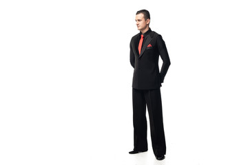 Fototapeta premium elegant tango dancer standing with hands behind back and looking away on white background