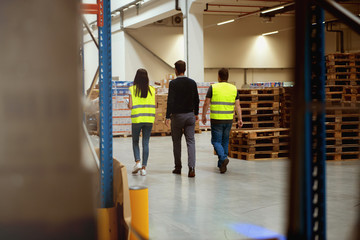 Working in warehouse, managers and workers