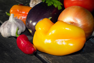 Fresh organic vegetables on a background of an old wooden table close-up.