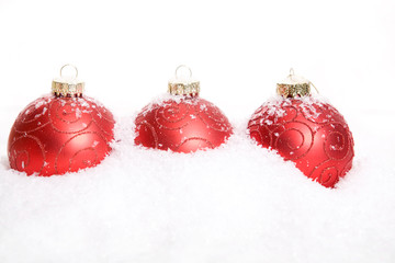 Red Christmas Baubles in snow