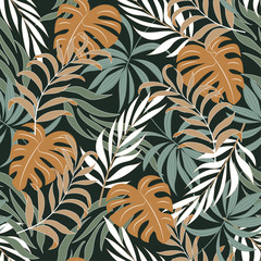 Abstract seamless tropical pattern with bright yellow plants and leaves on a green background. Modern abstract design for fabric, paper, interior decor. Tropical botanical.