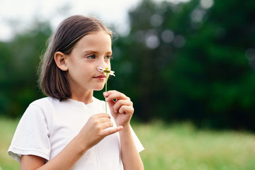 Fototapeta premium young woman blowing dandelion